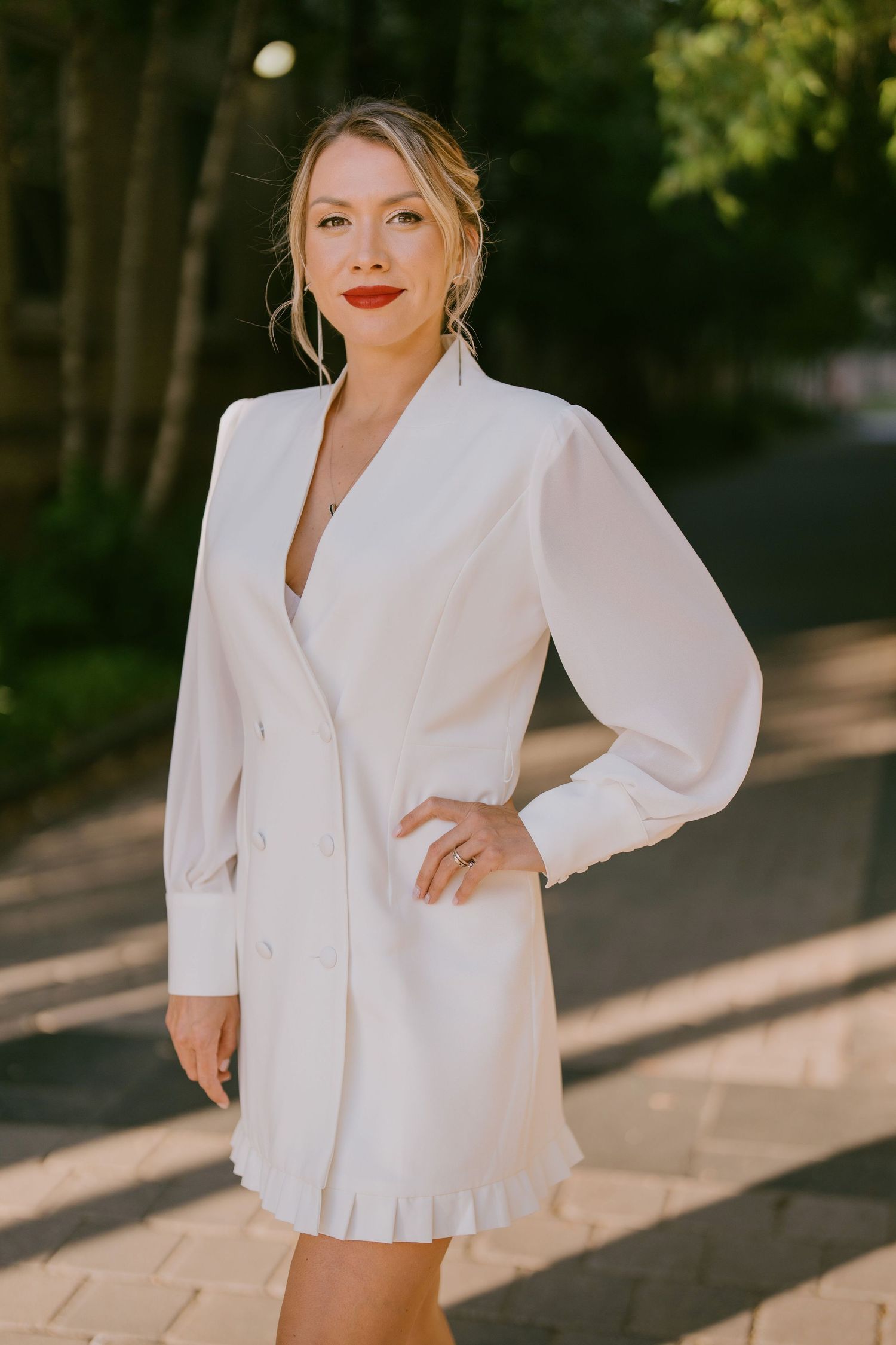 Modern lifestyle portrait of woman posing in white blazer dress outdoors in Toronto