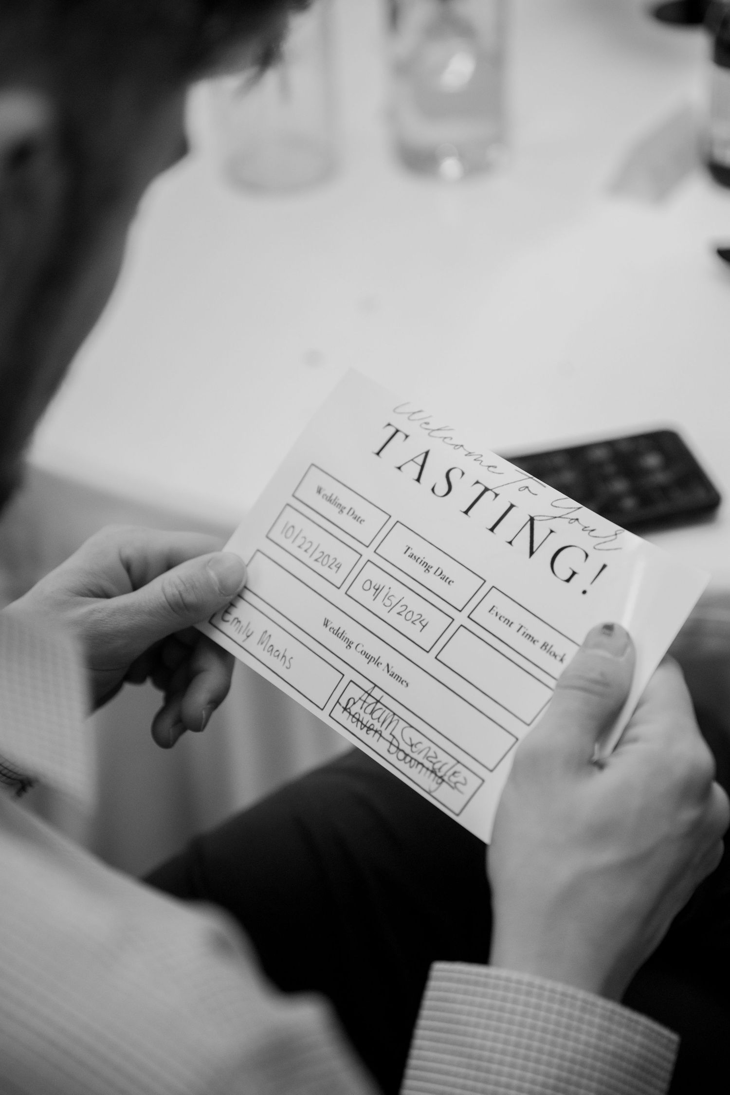 A black and white photograph shows hands holding a casting form or audition sheet.