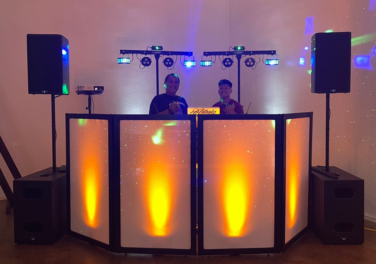 Professional DJ booth setup with illuminated panels and blue lighting for events and parties.