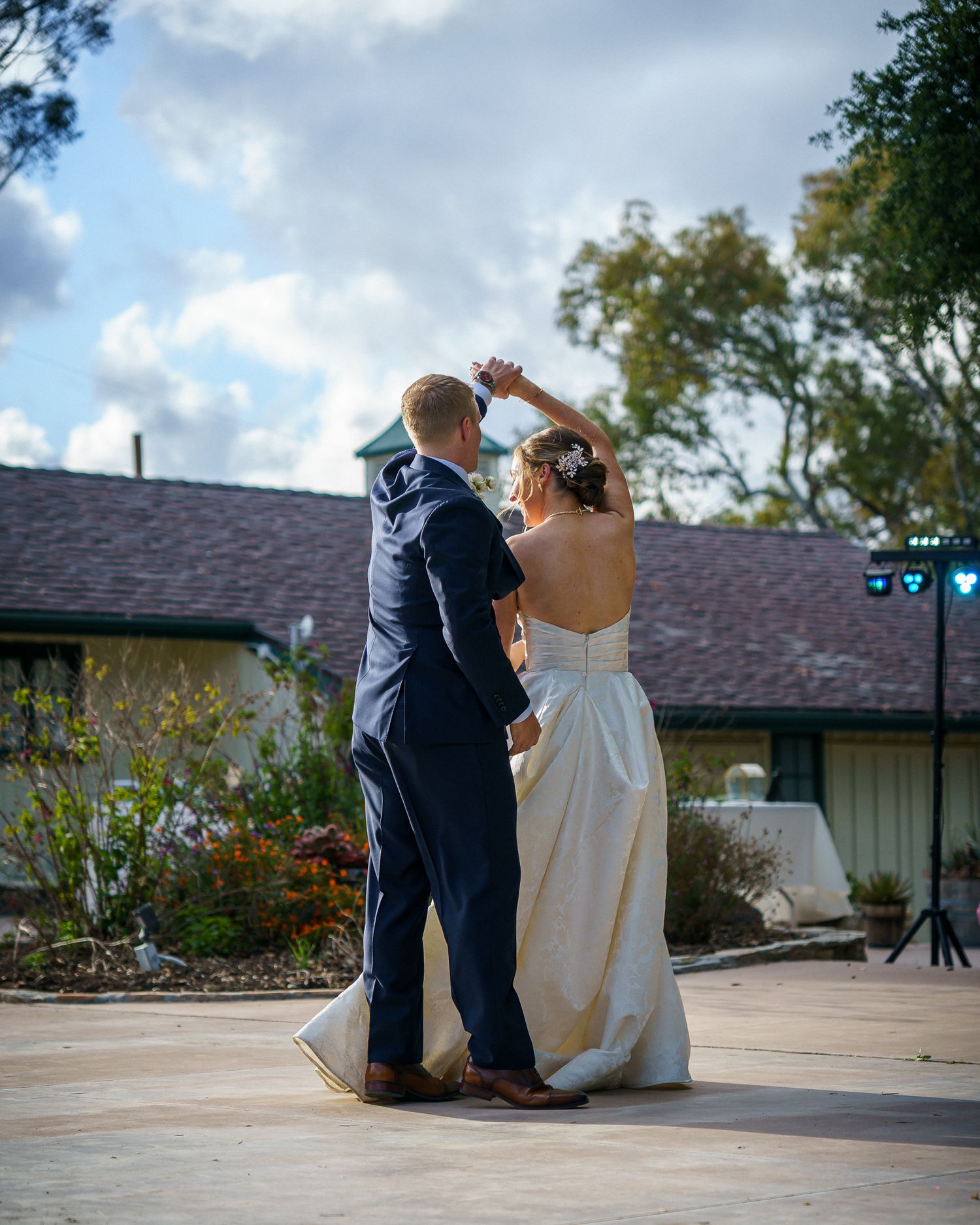 A couple sits close together on an outdoor deck during their wedding day, captured in sequence from different angles.