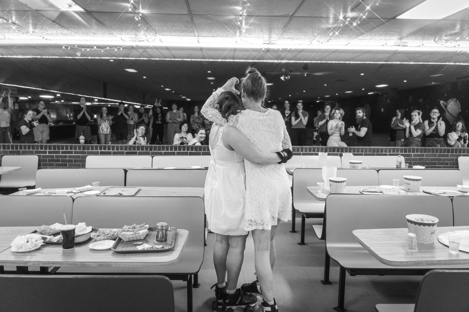 Wide view of bowling alley lanes with players lined up ready to compete in a tournament.