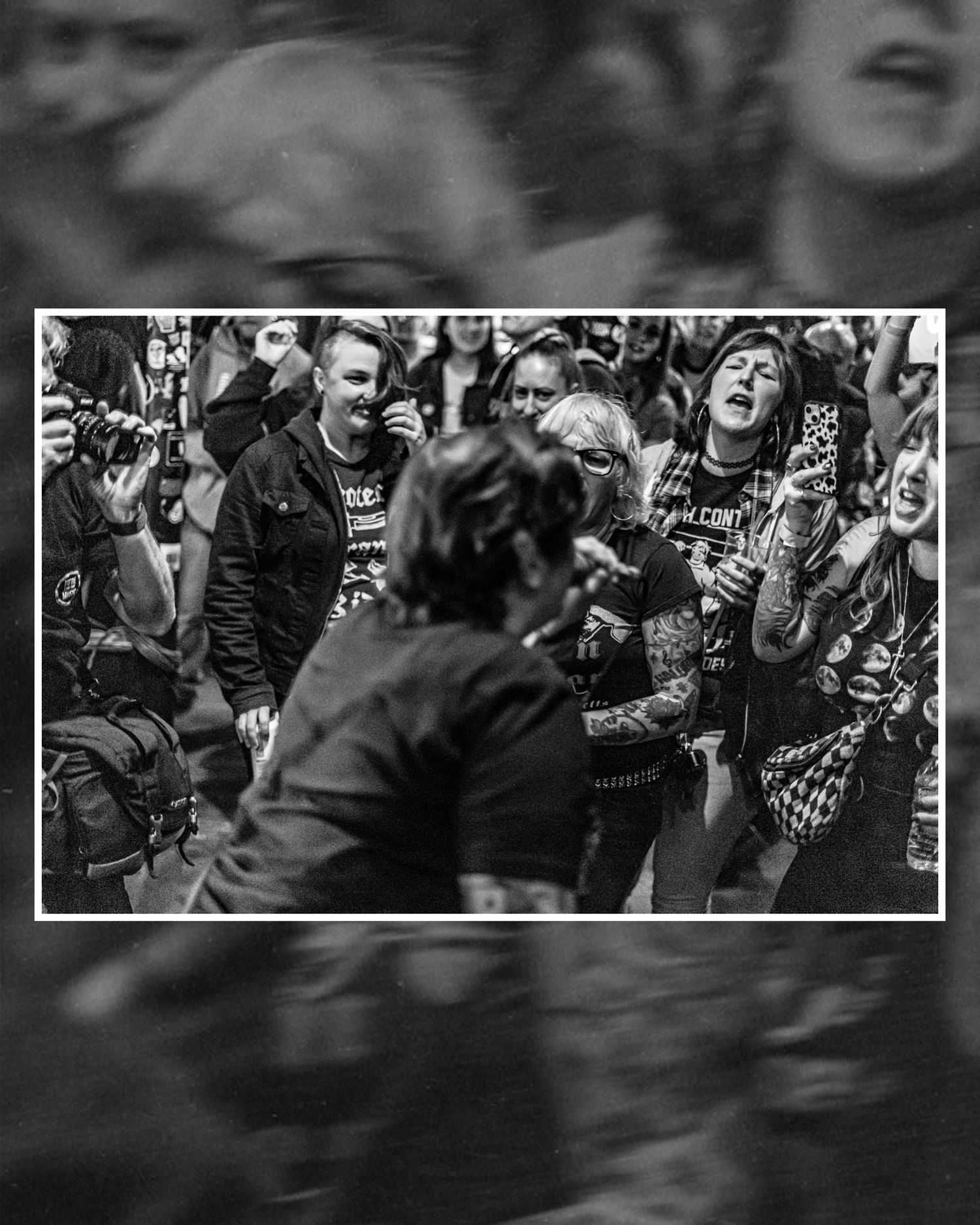 Black and white photo of energetic people dancing and moshing at a punk rock concert. Boston-based event photography.