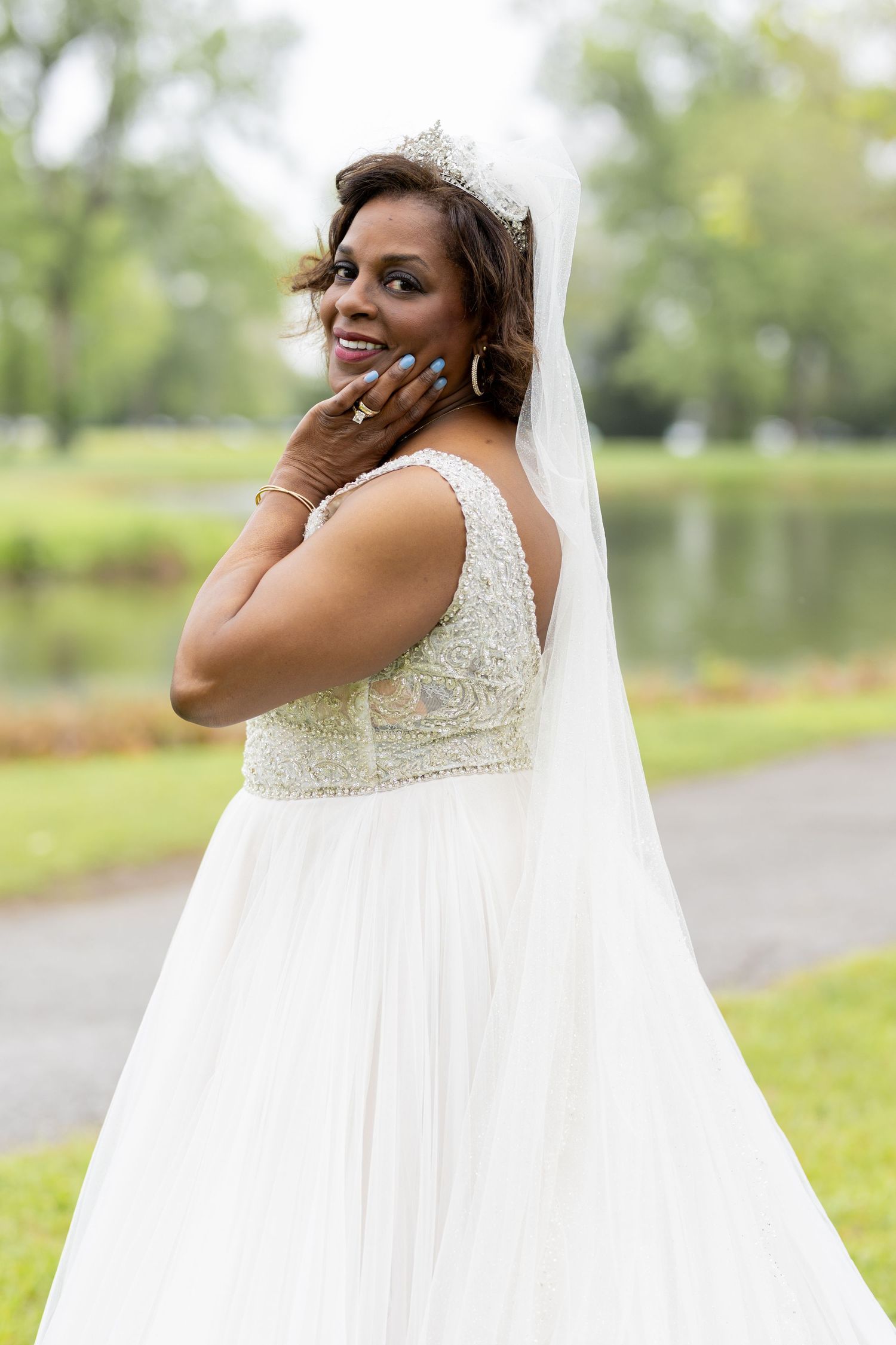 Beautiful bridal portrait showing off an elegant lace wedding gown and veil.