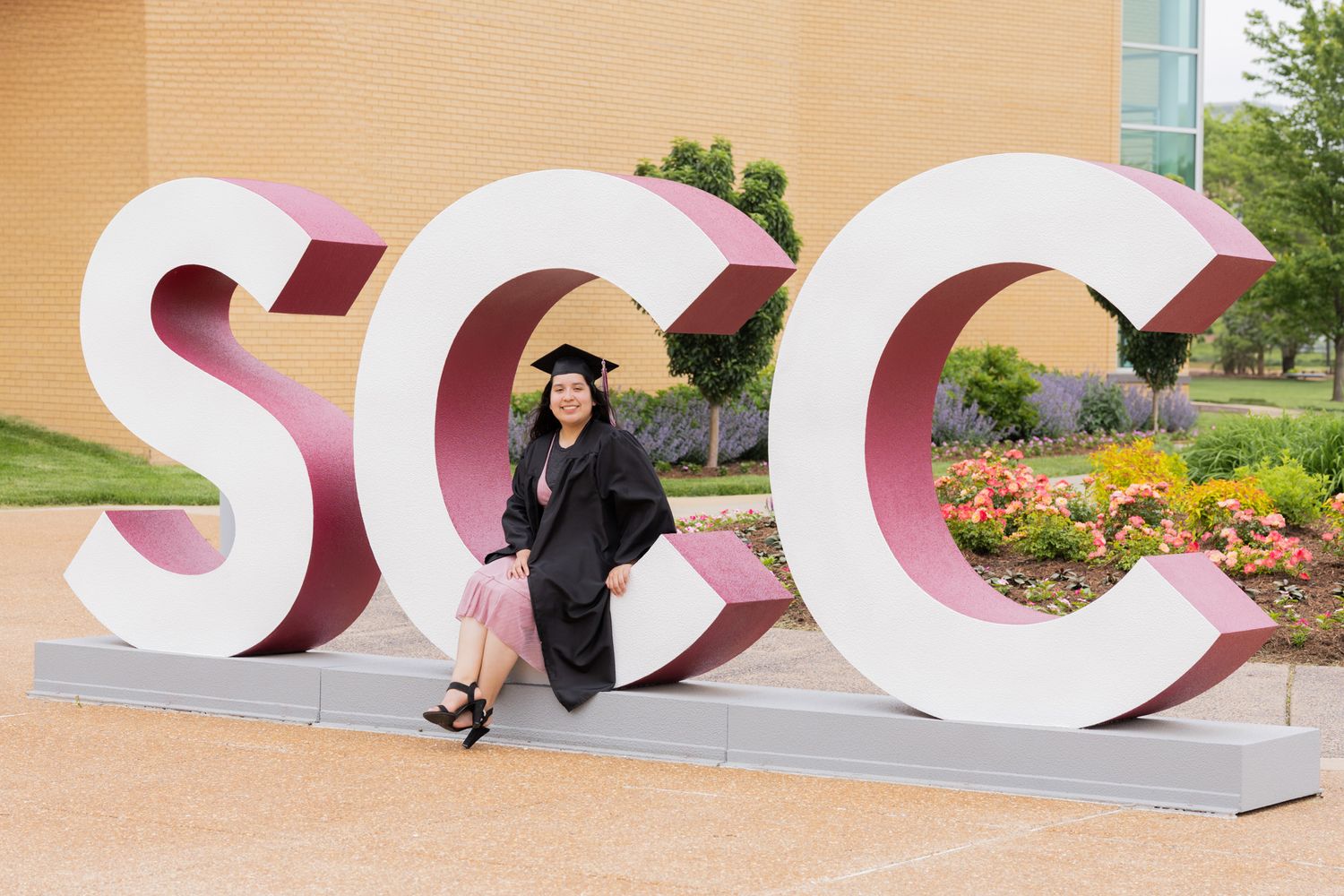 A graduation photo featuring large SCC letters as an outdoor display installation.