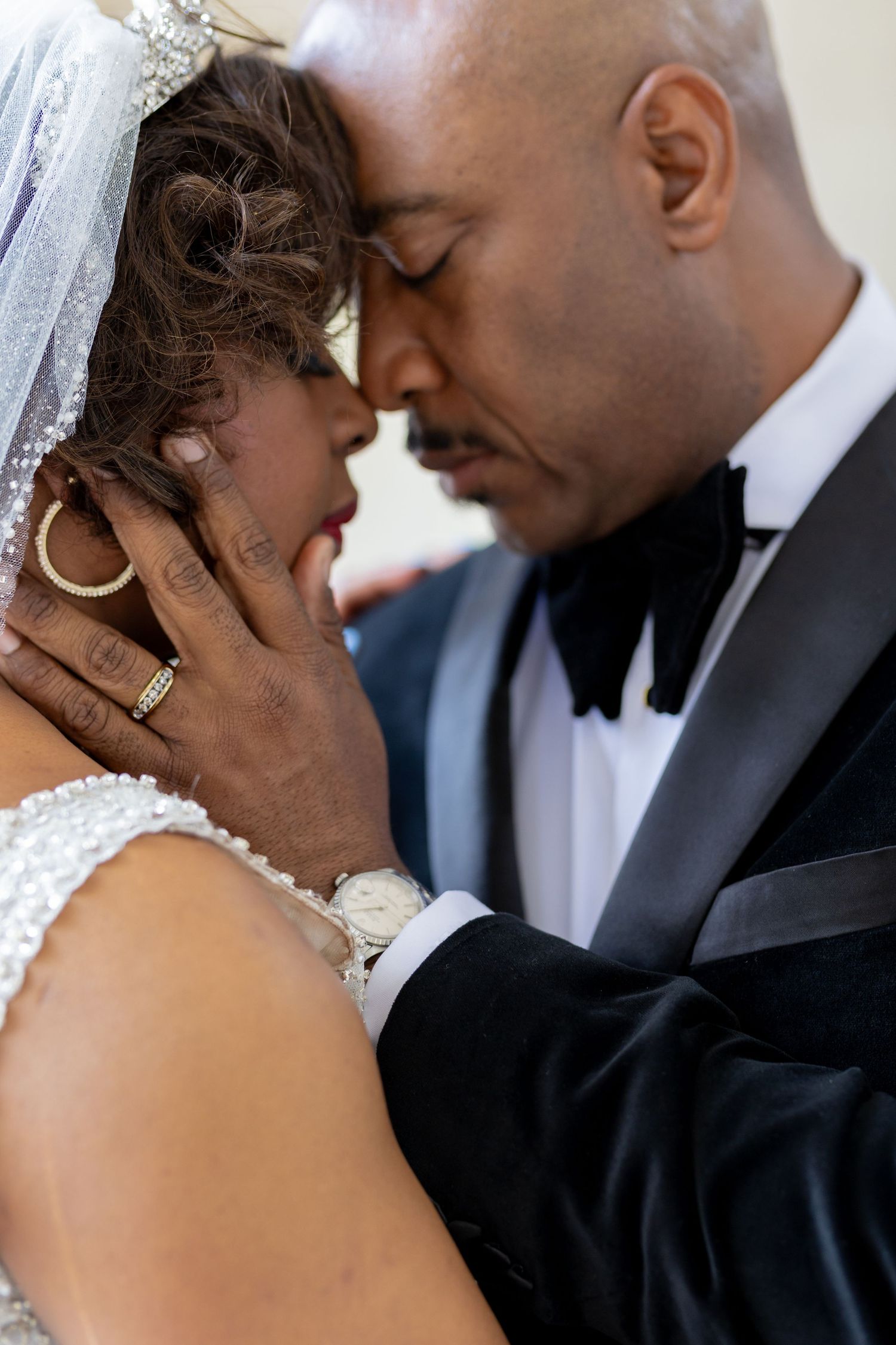 An intimate wedding portrait showing a tender moment between newlyweds.