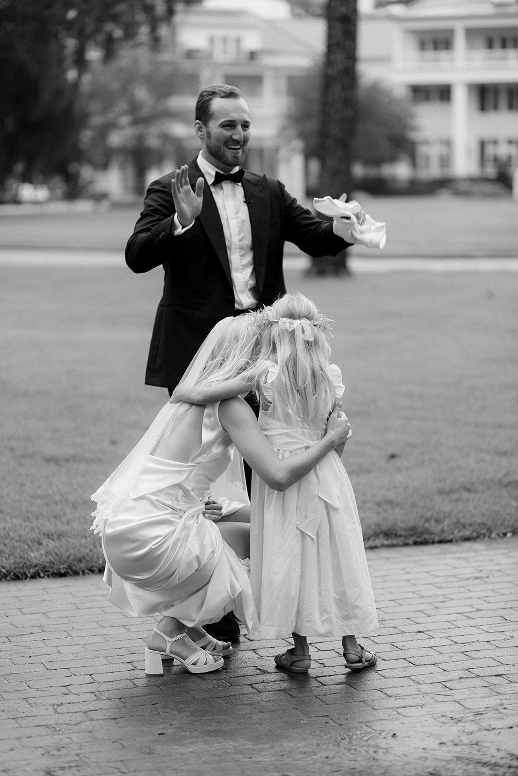 A black and white photo sequence shows a close up of two pairs of feet dancing together on a stone pathway.