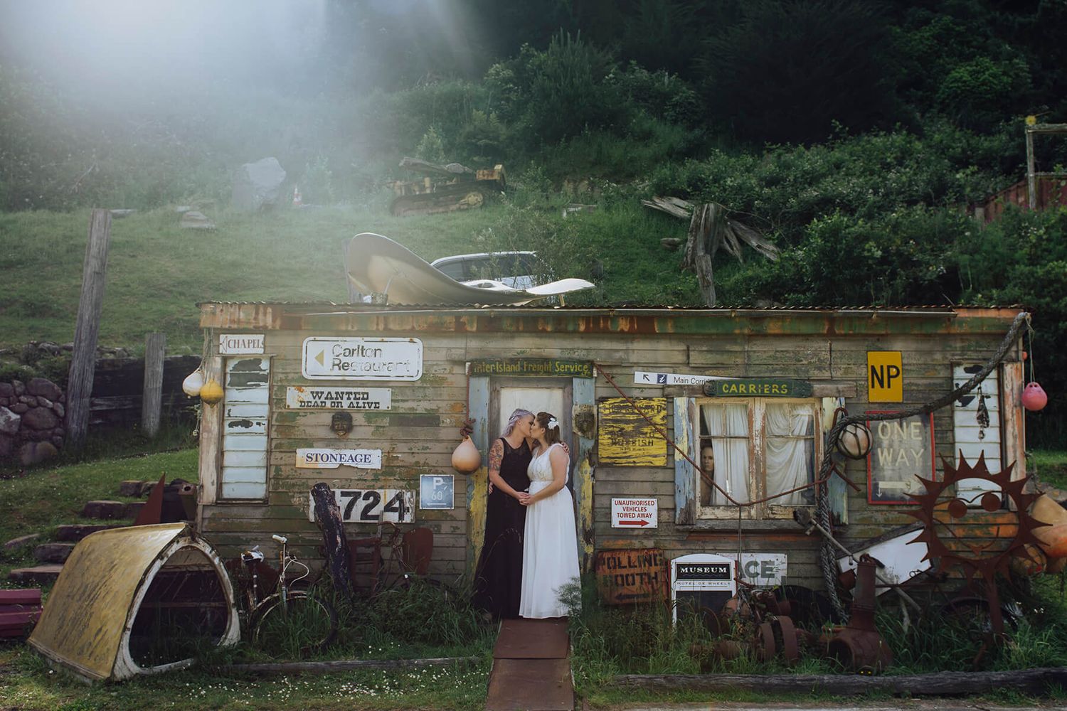 Two brides kissing in a mini golf park in Wellington, NZ - Zara King Photography