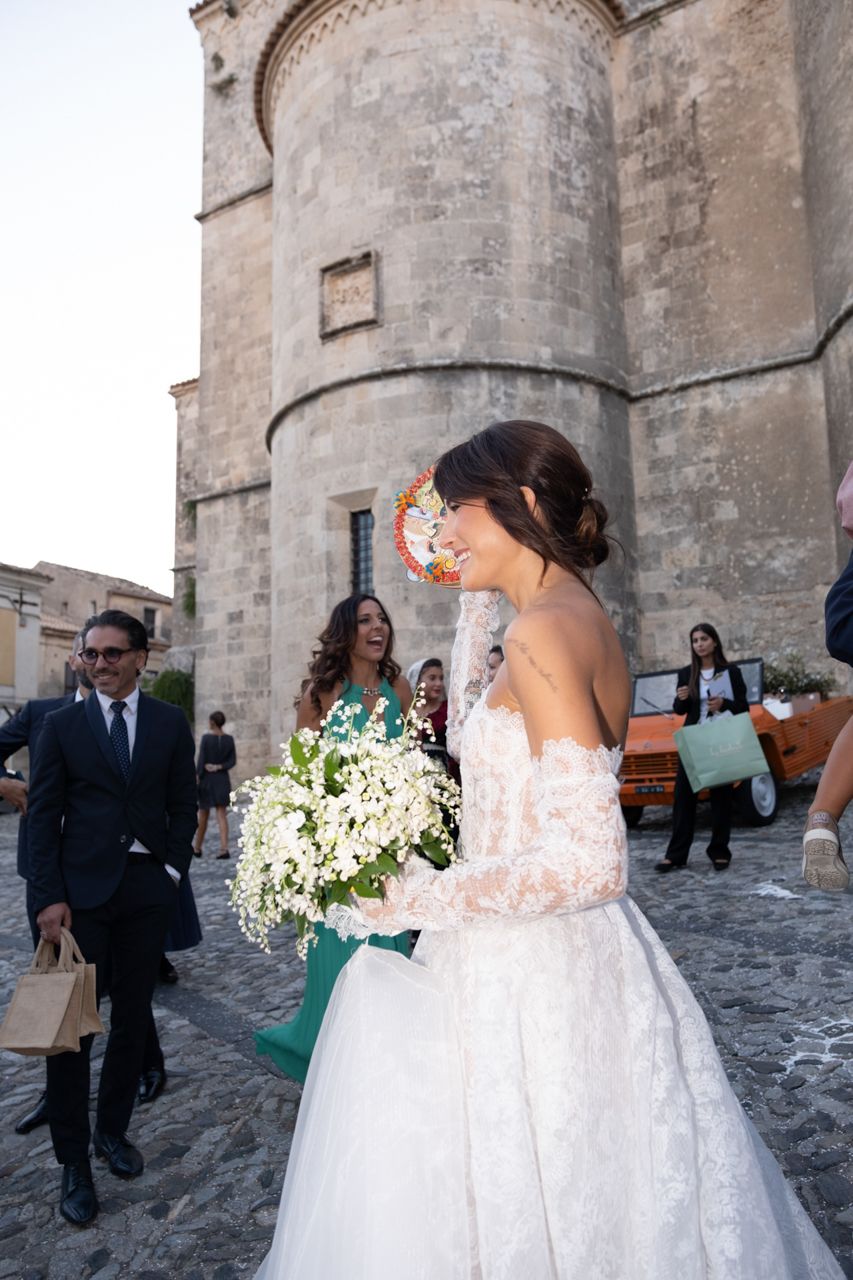 A joyful wedding scene outside a historic stone church with classic architecture.