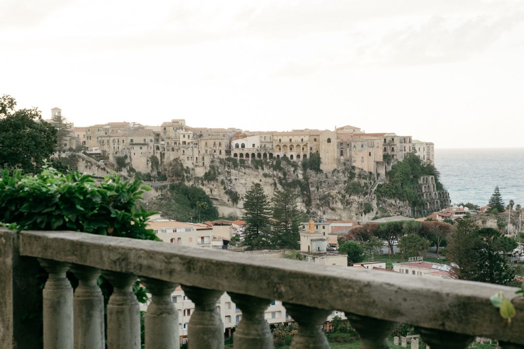 Historic Mediterranean cliff-side town with ancient architecture overlooking the sea.
