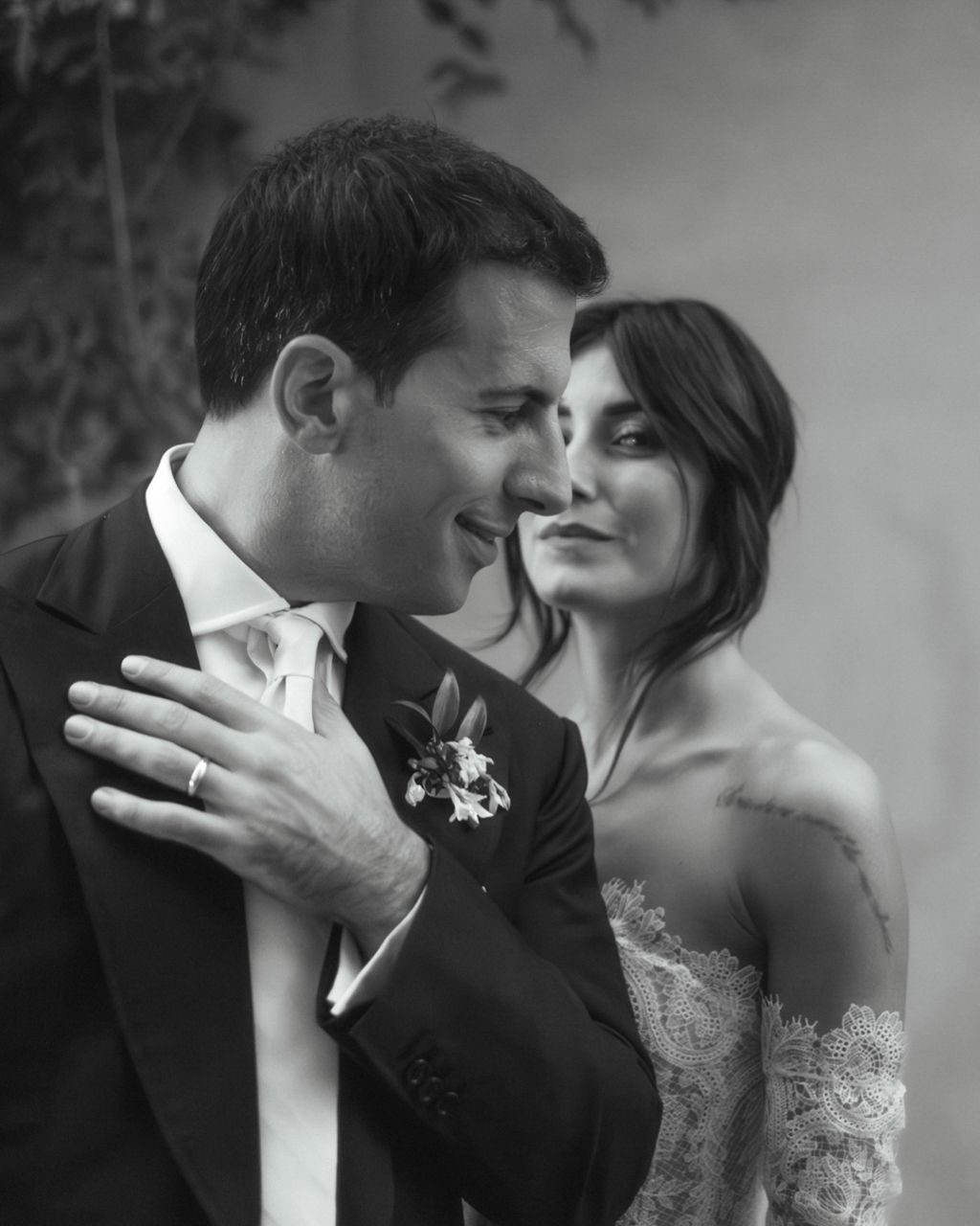Intimate black and white portrait of newlyweds sharing tender moment.