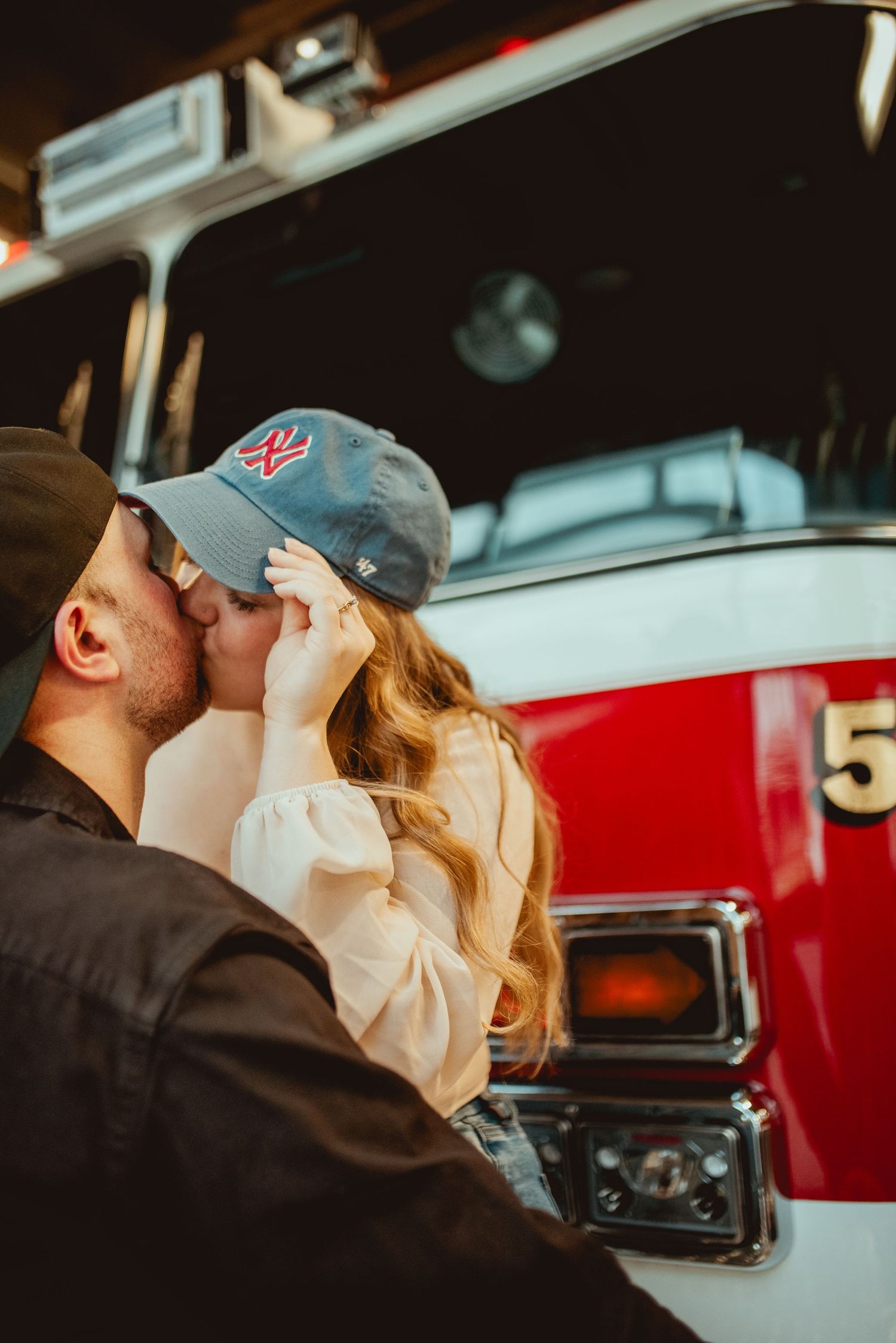 Sweet candid moment captured between couple at fire station.