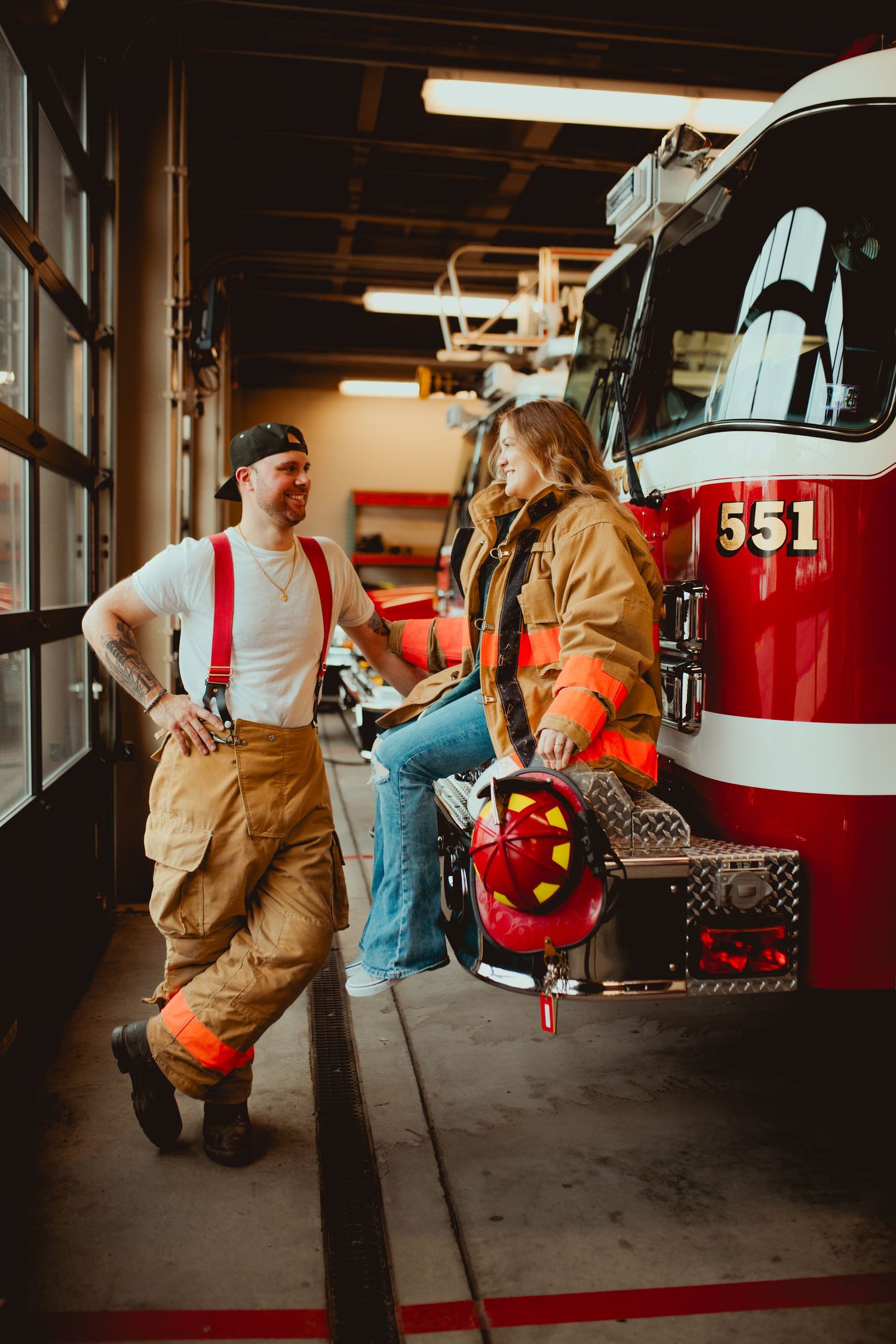 Fire station interior with red fire truck number 551 visible in the background.