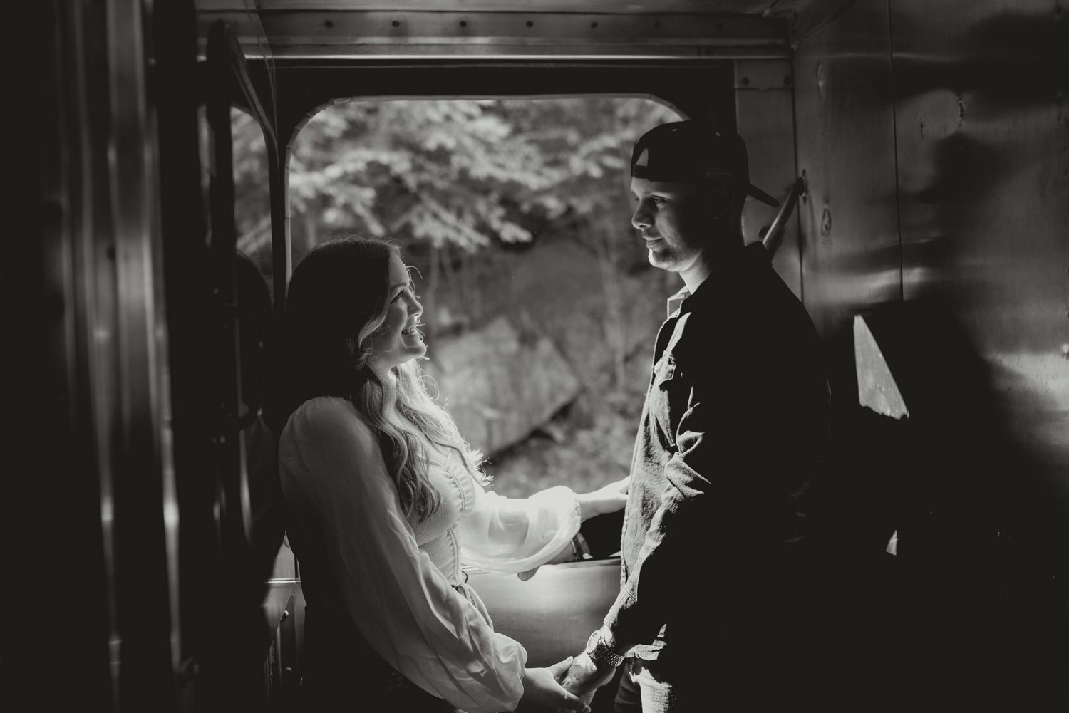 Black and white sequence shows atmosphere of a vintage commuter train station platform.