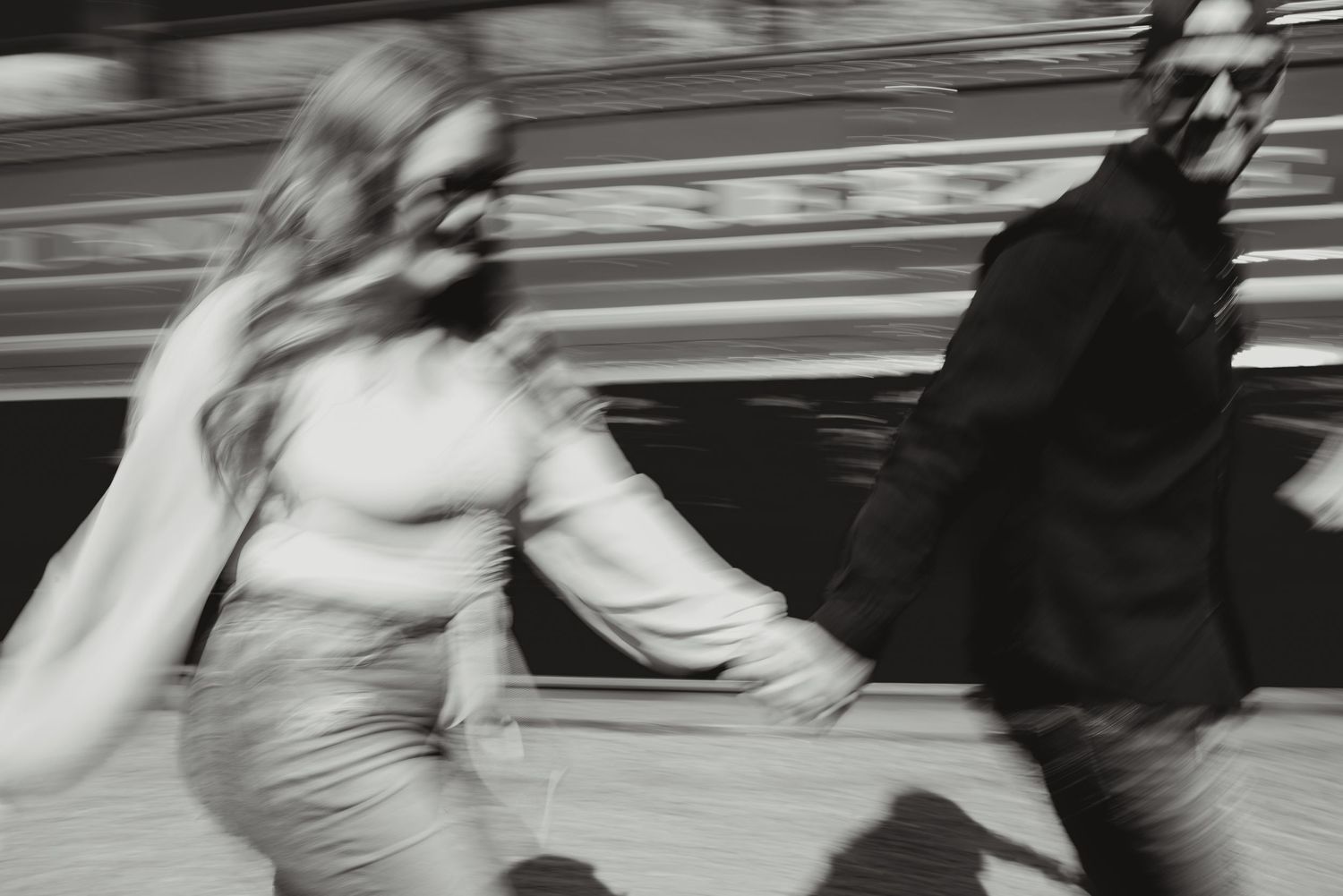 Motion blurred black and white images capture people rushing through a train station.