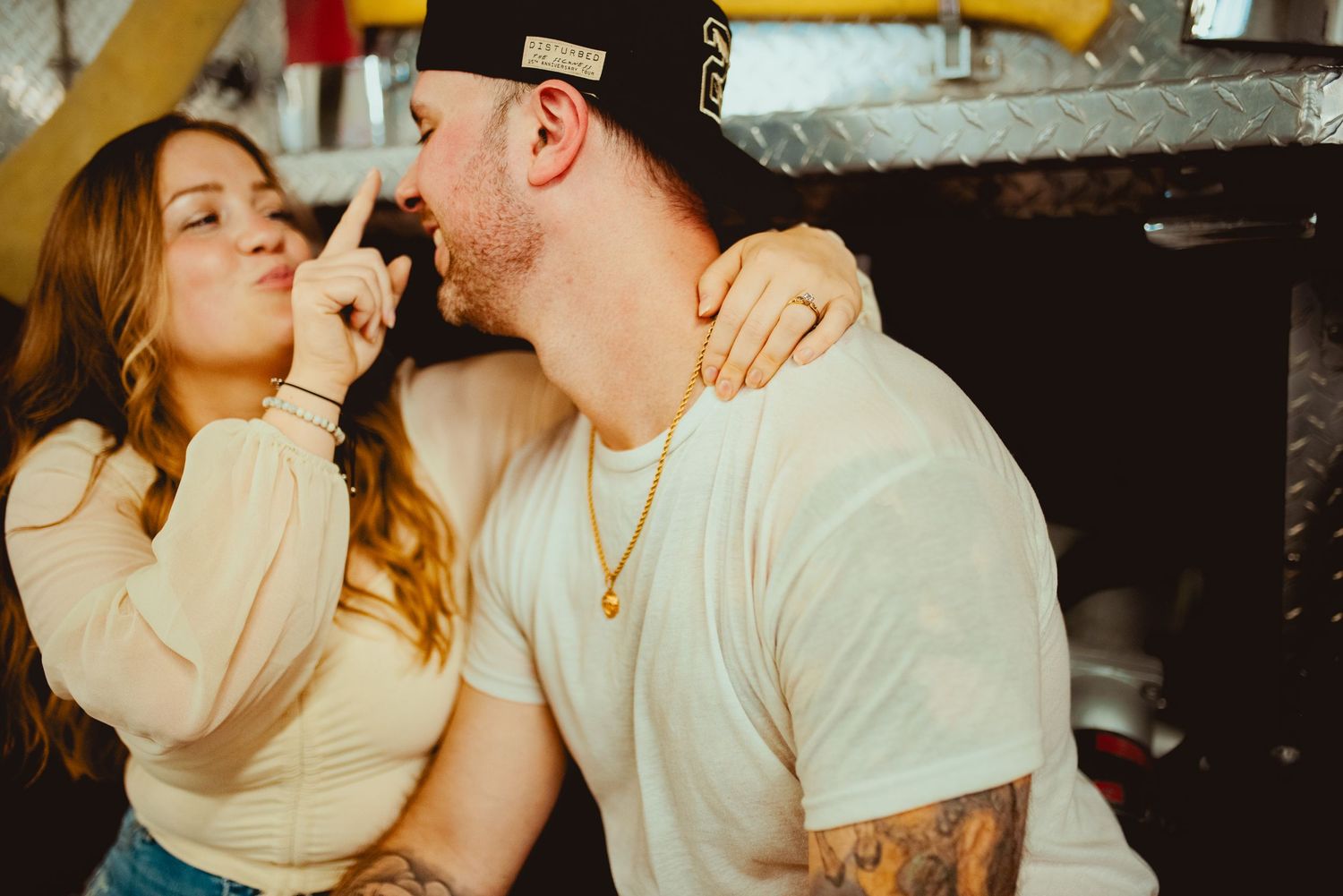 Affectionate moment captured between couple at fire station.