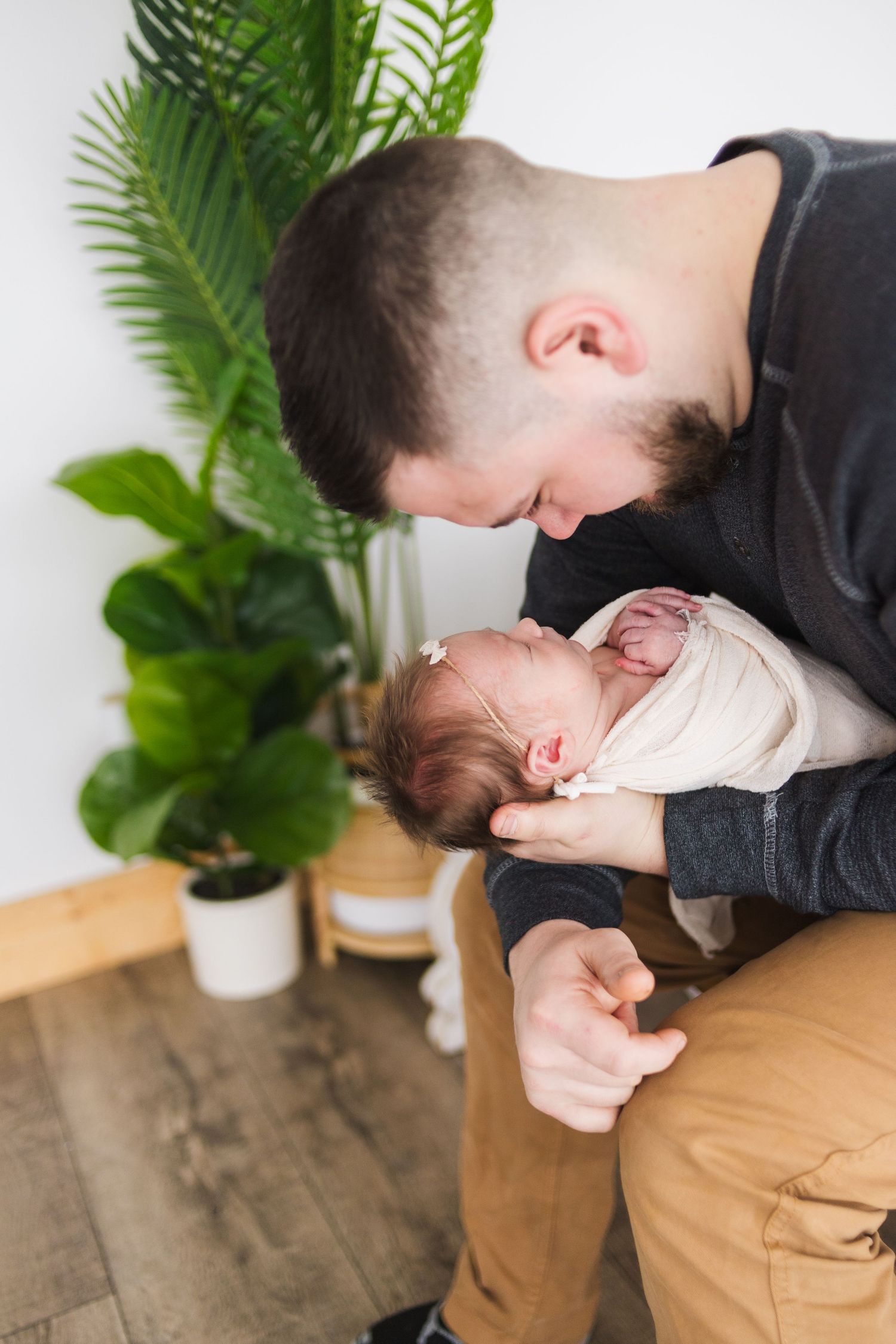 Tender moment: dad and newborn baby girl touching noses – lifestyle newborn session Springfield MO