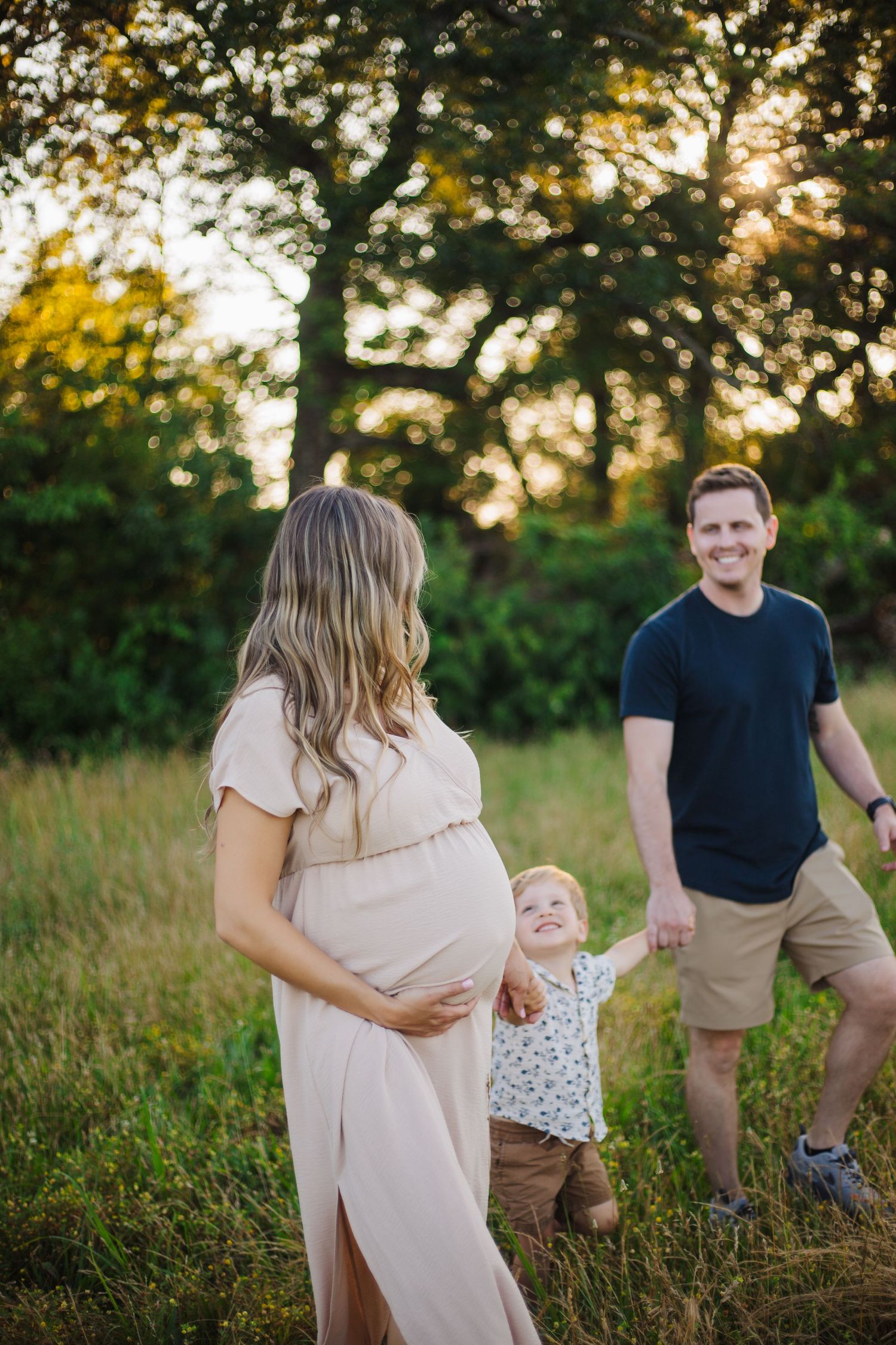 Maternity photographer Springfield MO – outdoor motherhood session with glowing sunset light and soft styling