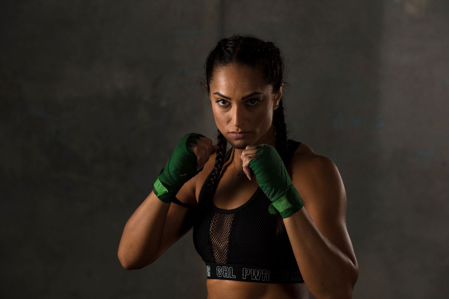 Fitness photoshoot featuring boxing poses against dark studio background.