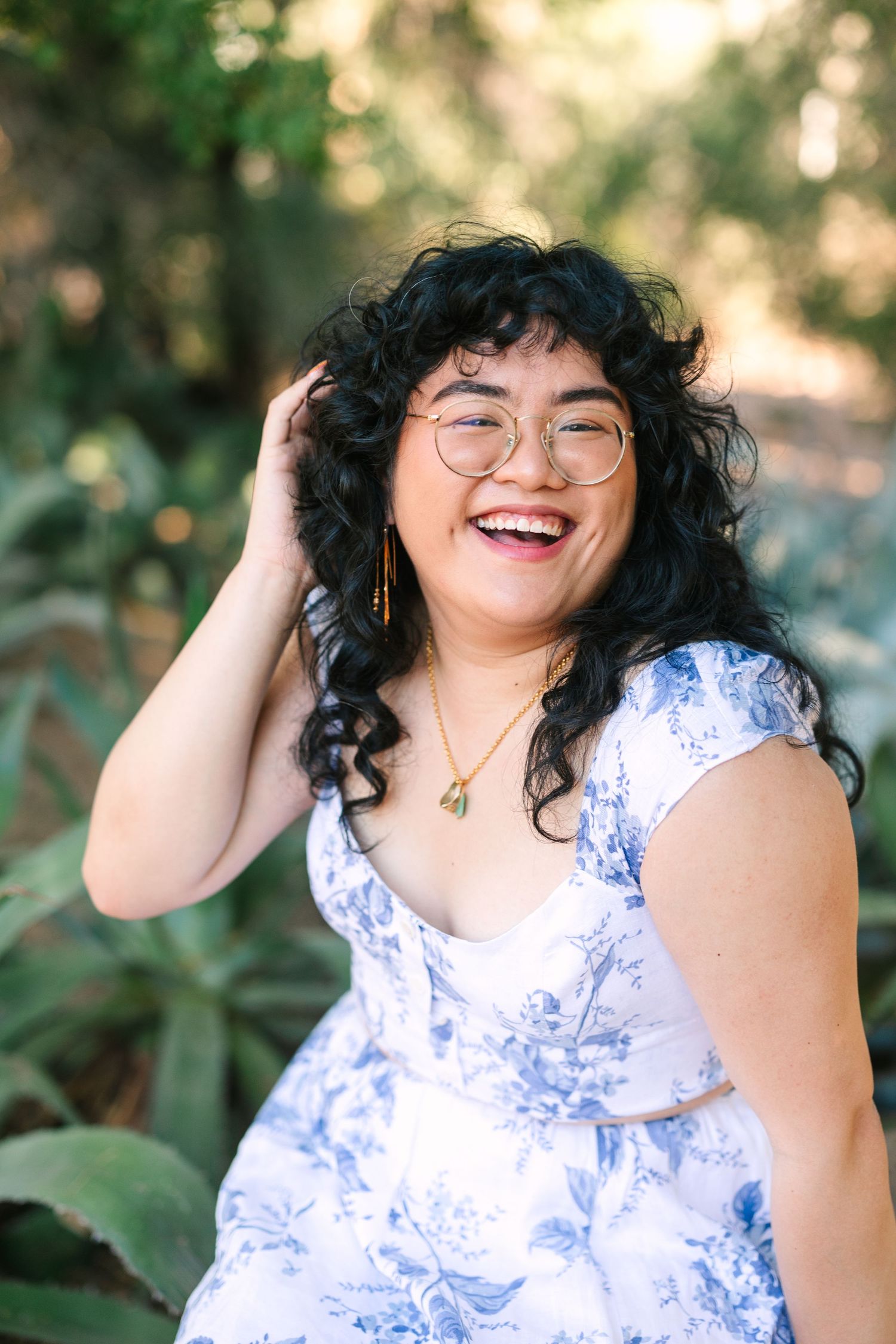 A sequence of candid shots showing someone wearing a white and blue floral dress against a natural outdoor background.