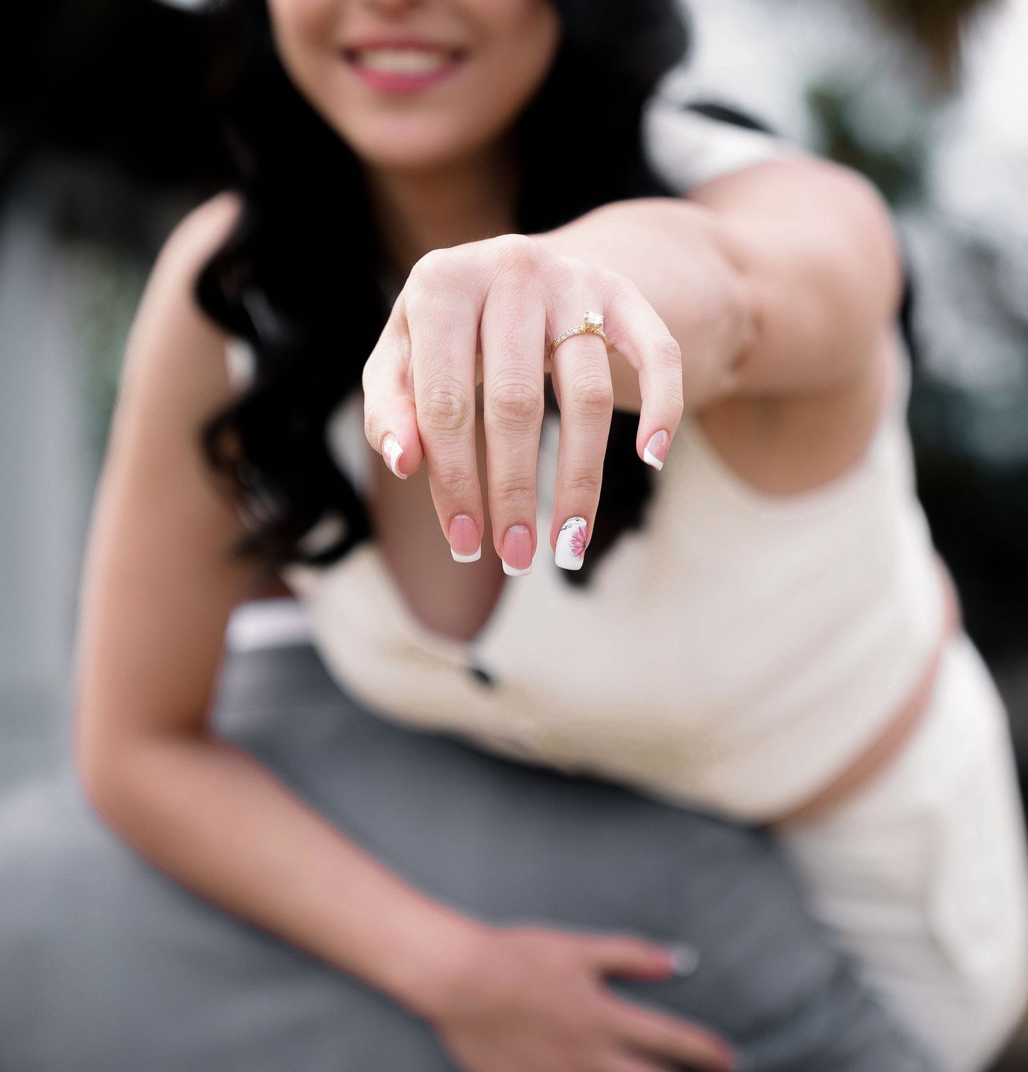 Close-up details of a bride showing wedding ring and manicured nails.