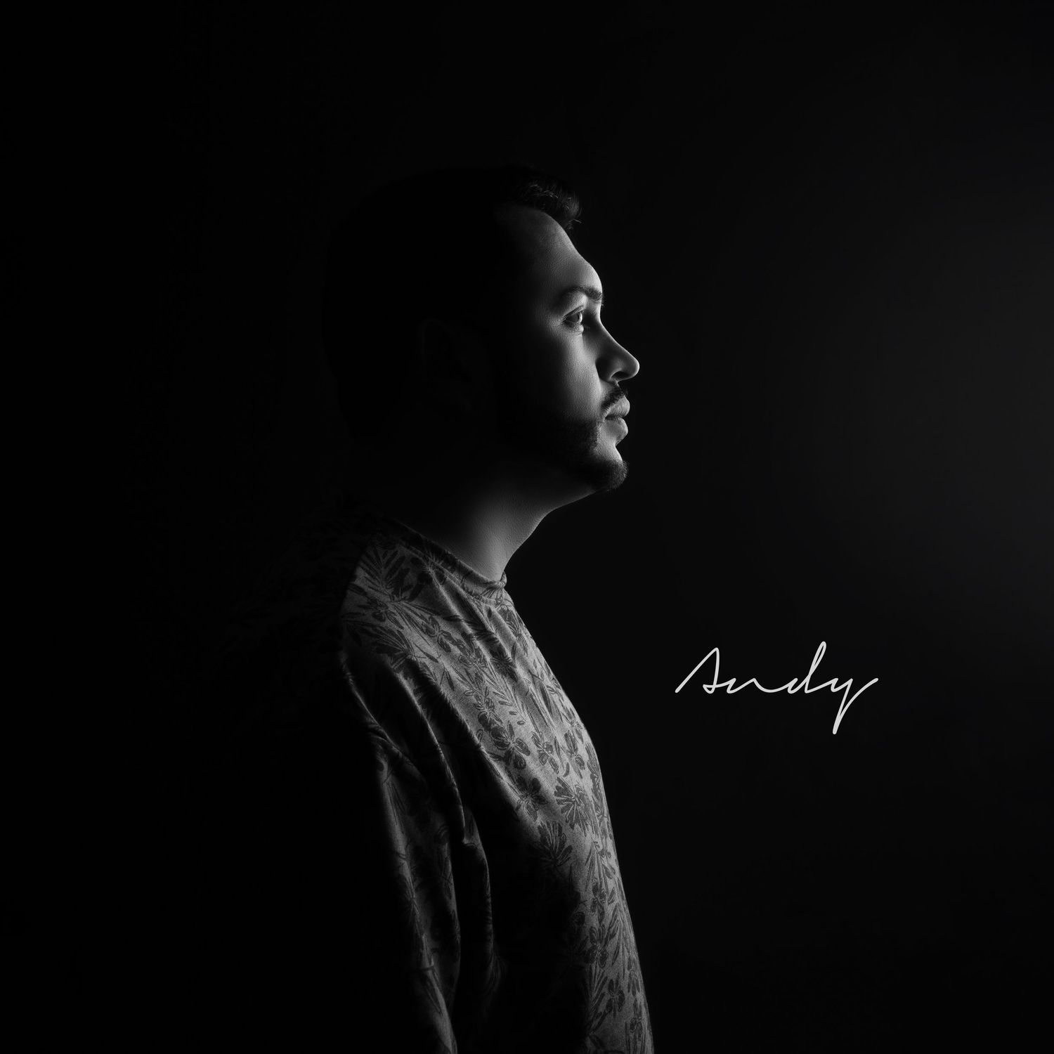 Black and white artistic profile portrait in dramatic lighting with signature text.
