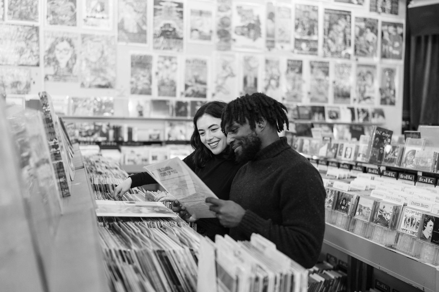 Customer browsing through vinyl records at a music store while wearing a face mask.