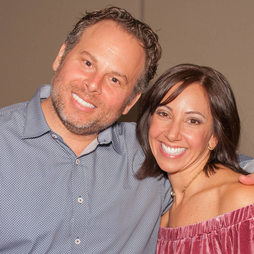 Happy couple smiling together at a social event.