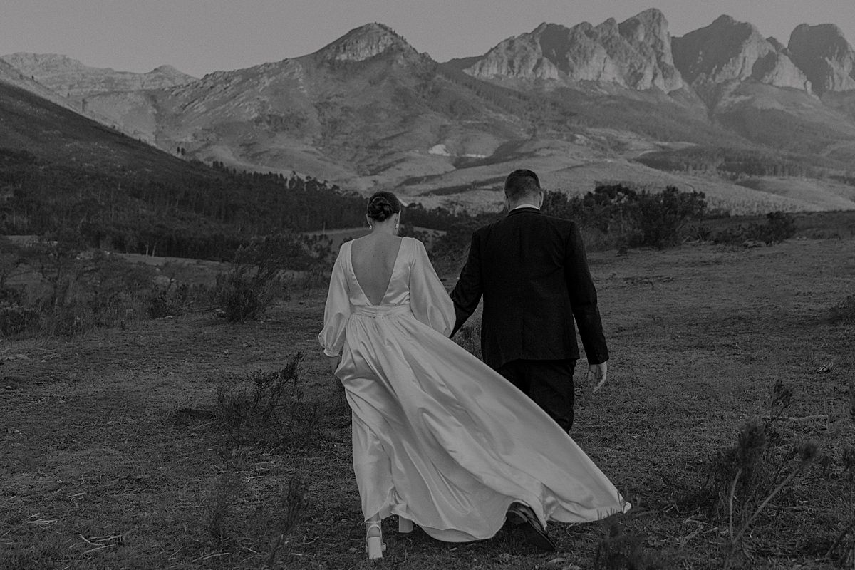 Bride and groom sharing a tender moment in golden sunlight at Cape Town wedding