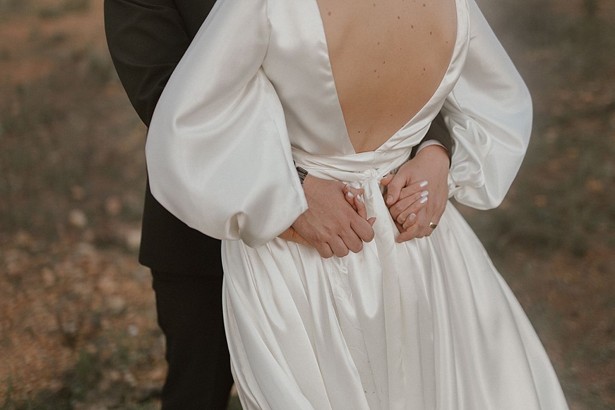 Bride and groom sharing a tender moment in golden sunlight at Cape Town wedding