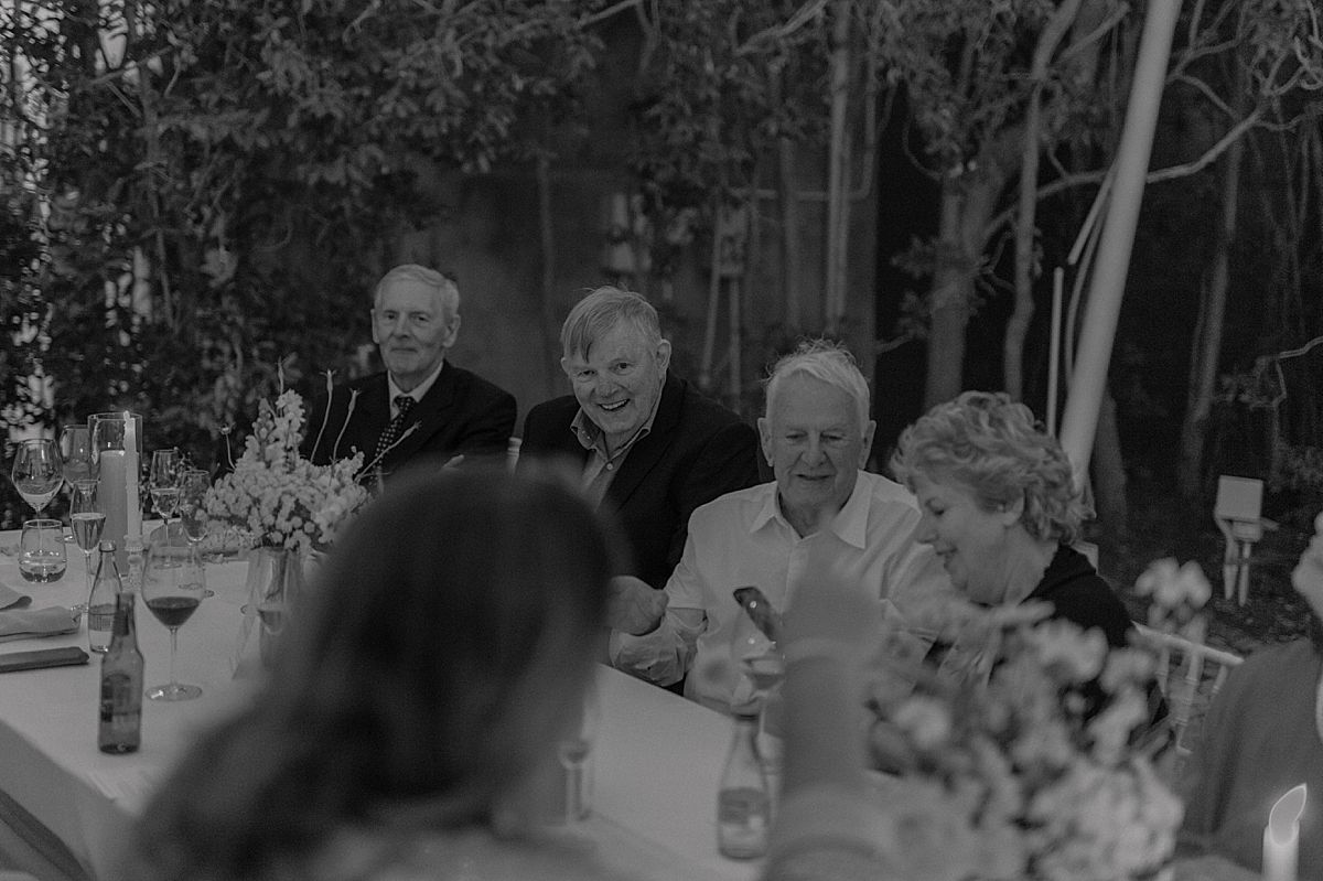 Bride and groom sharing a joyful moment at Weltevreden Estate, with elegant floral arrangements and Cape Dutch architecture.