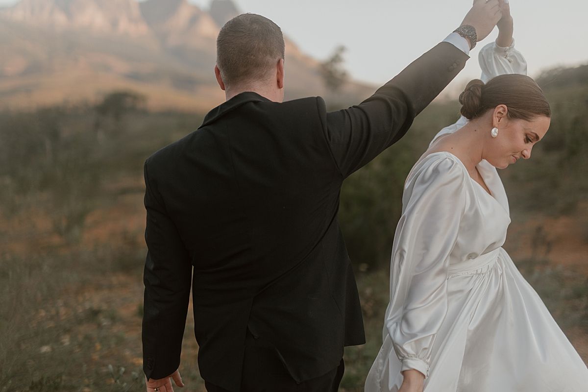 Bride and groom sharing a tender moment in golden sunlight at Cape Town wedding