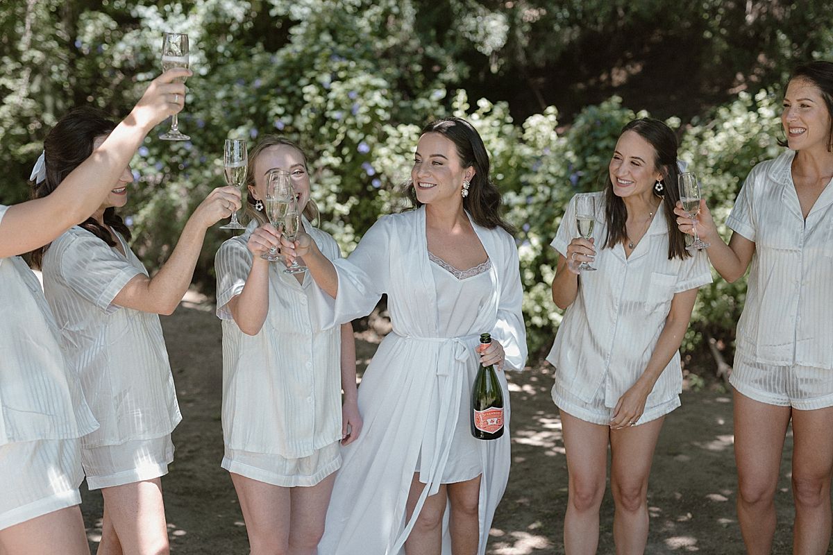 Bride and groom sharing a joyful moment at Weltevreden Estate, with elegant floral arrangements and Cape Dutch architecture.