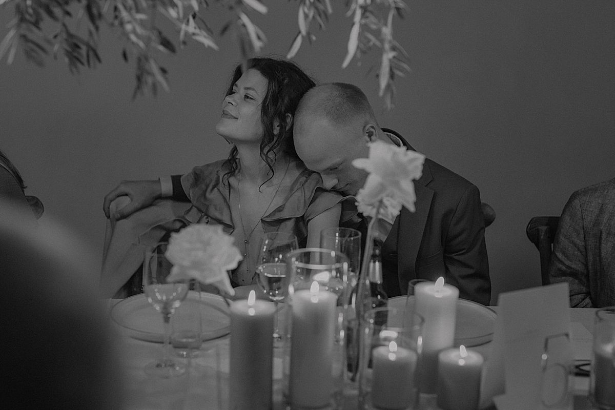 Guests raising glasses for a joyful wedding toast in stylish venue