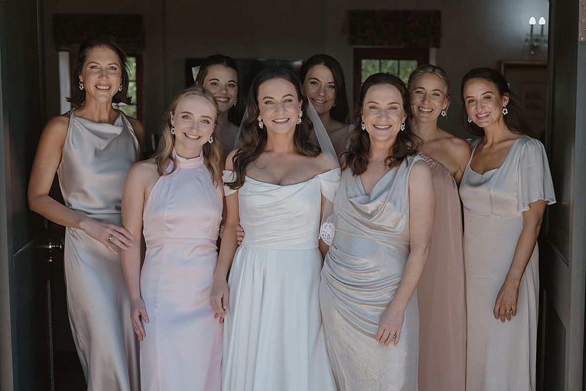 Bride and groom sharing a joyful moment at Weltevreden Estate, with elegant floral arrangements and Cape Dutch architecture.