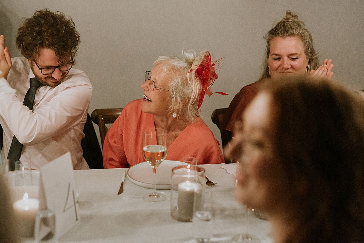 Guests raising glasses for a joyful wedding toast in stylish venue