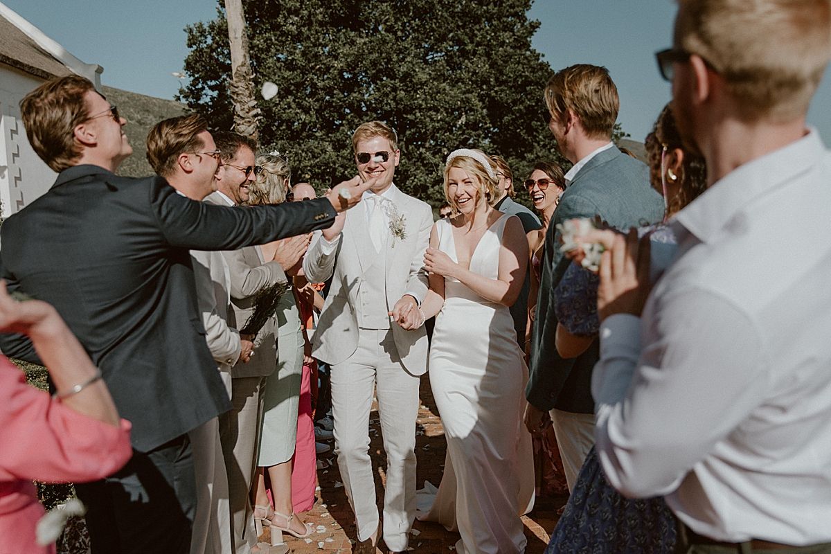 Bride and groom exchanging vows at Penhill FarmIntimate wedding reception in Cape Dutch venue at Penhill Farm