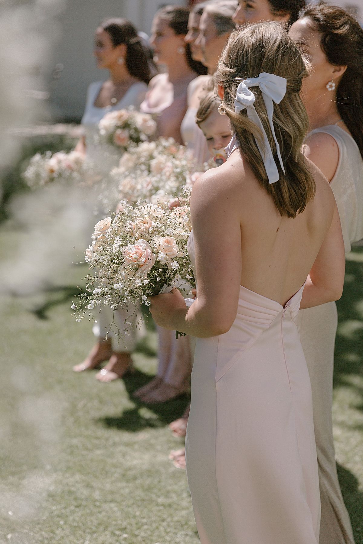 motional moment as couple says “I do” surrounded by family and friends