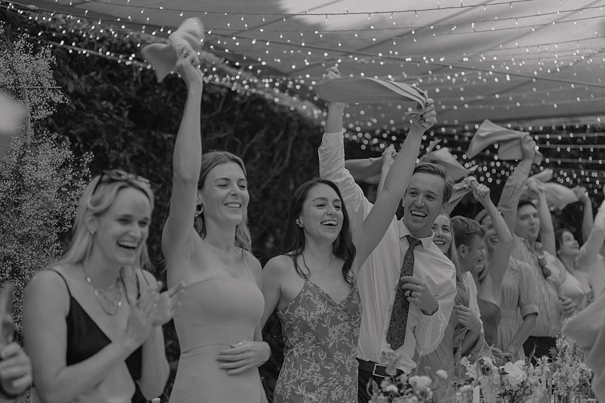Bride and groom sharing a joyful moment at Weltevreden Estate, with elegant floral arrangements and Cape Dutch architecture.