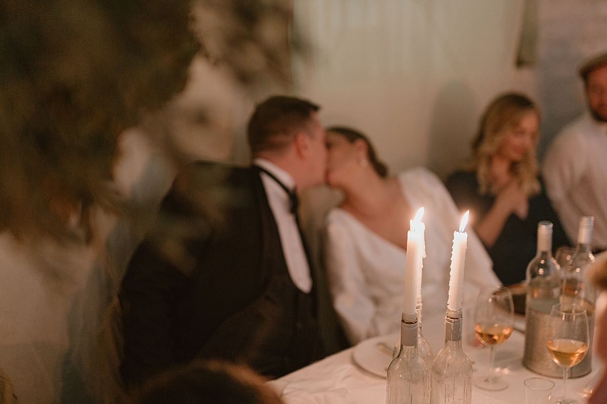 Newlyweds smiling and toasting guests during joyful wedding reception celebration