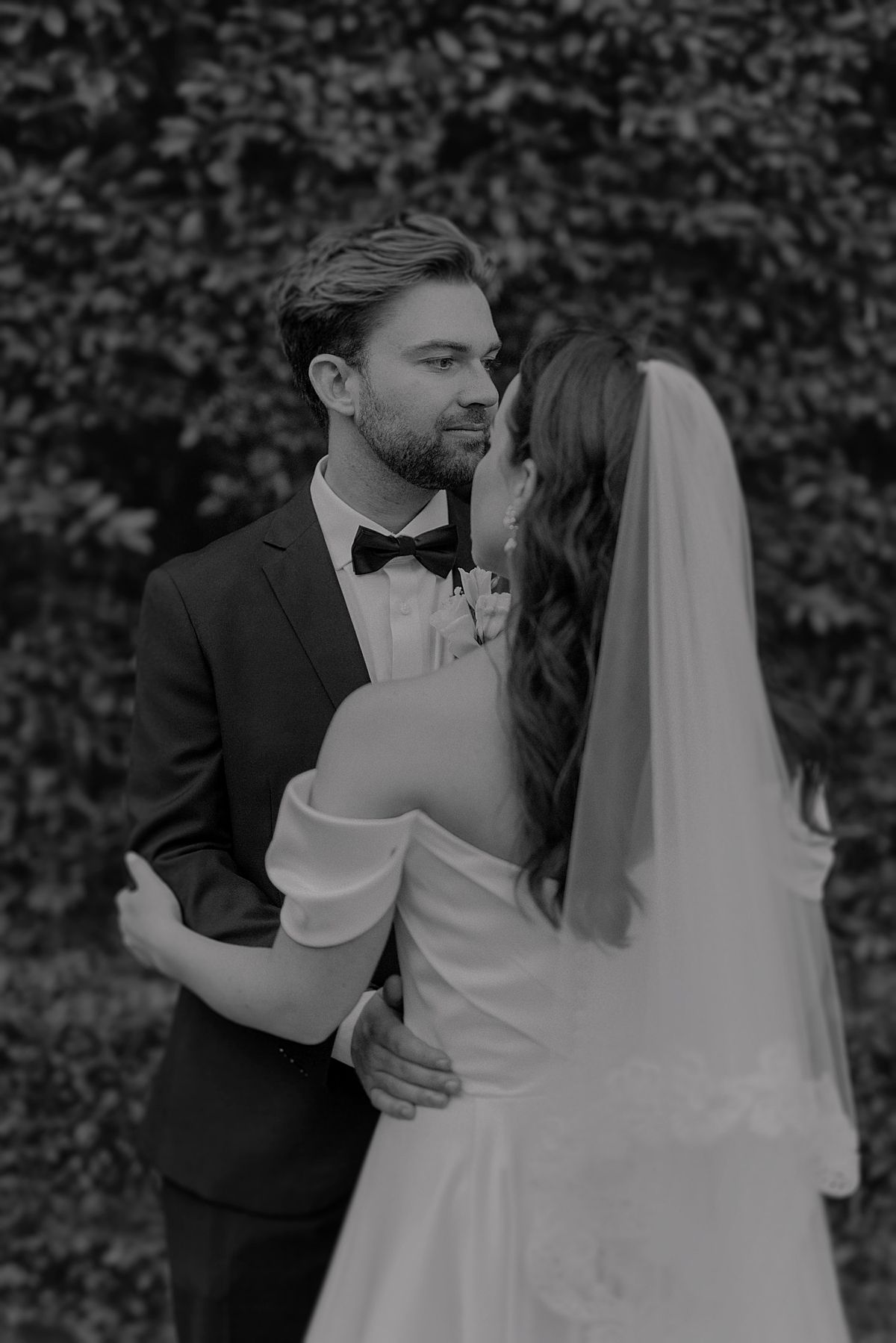 Bride and groom sharing a joyful moment at Weltevreden Estate, with elegant floral arrangements and Cape Dutch architecture.