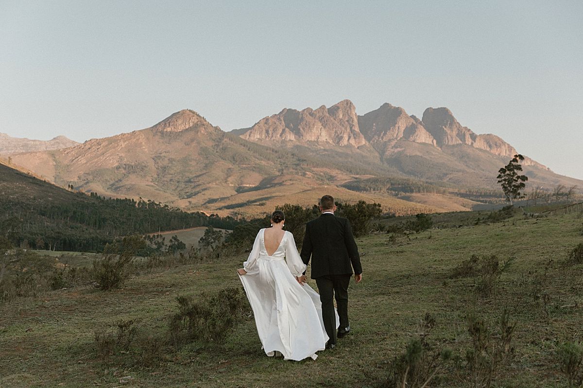 Bride and groom sharing a tender moment in golden sunlight at Cape Town wedding