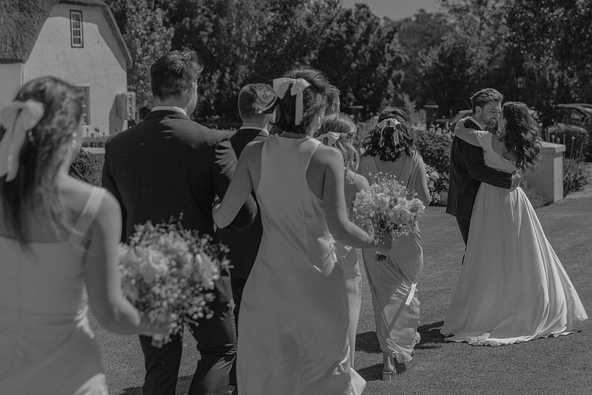 motional moment as couple says “I do” surrounded by family and friends