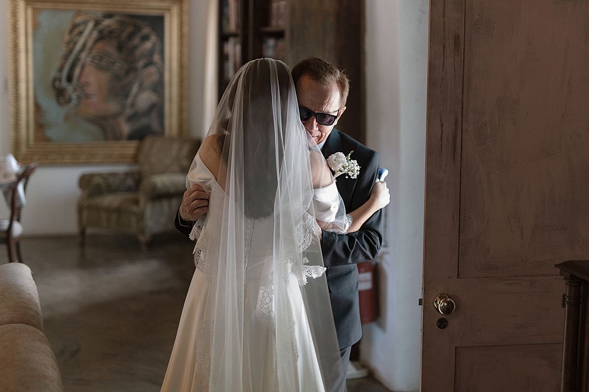 Bride and groom sharing a joyful moment at Weltevreden Estate, with elegant floral arrangements and Cape Dutch architecture.