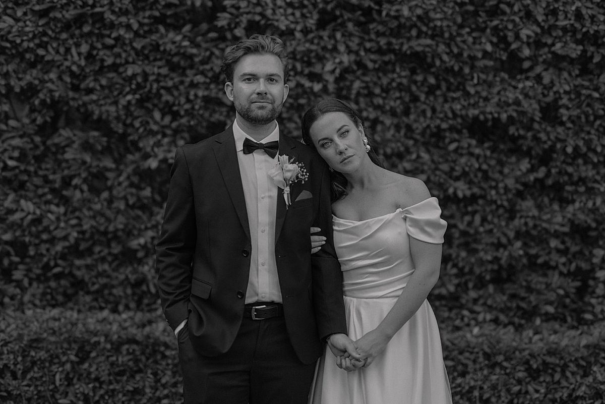 Bride and groom sharing a joyful moment at Weltevreden Estate, with elegant floral arrangements and Cape Dutch architecture.