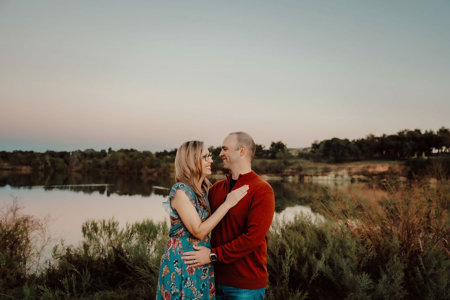 Seven romantic outdoor engagement photos showing a couple embracing in a golden field at sunset.