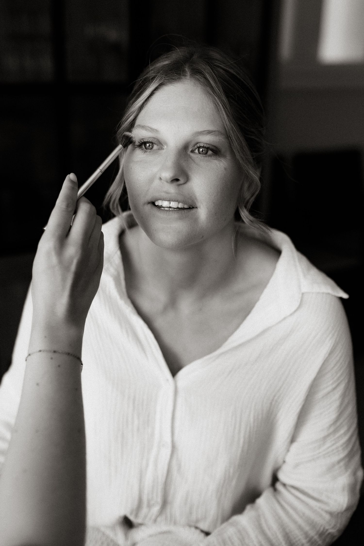 Getting ready moment during wedding preparations in black and white.
