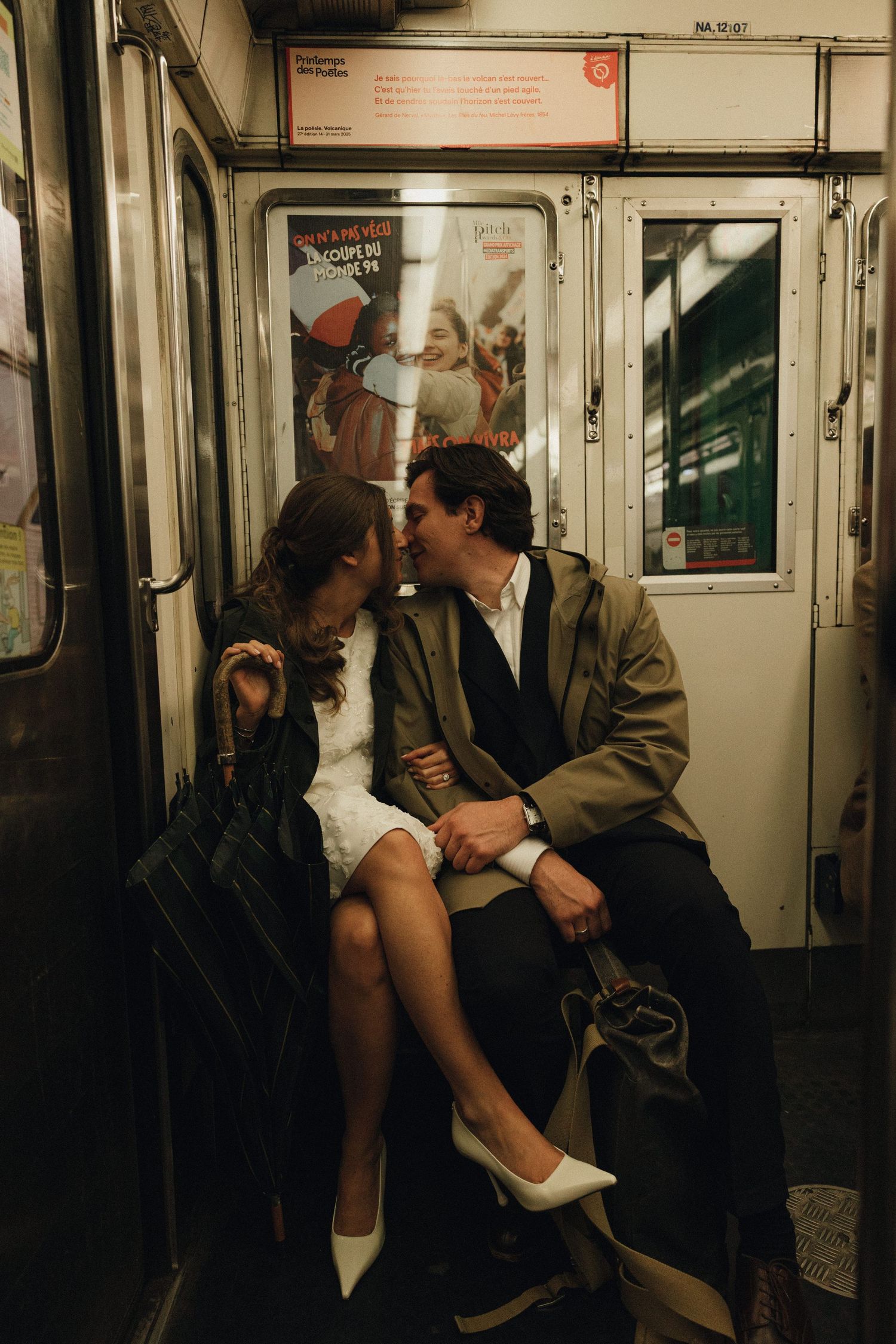 A romantic scene unfolds on a subway car as a couple shares an intimate moment on the train.