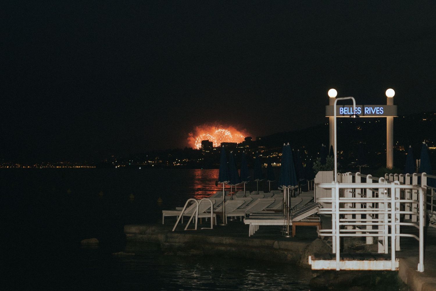 Multiple nighttime images show dark landscapes with distant lights and structures against a black sky.