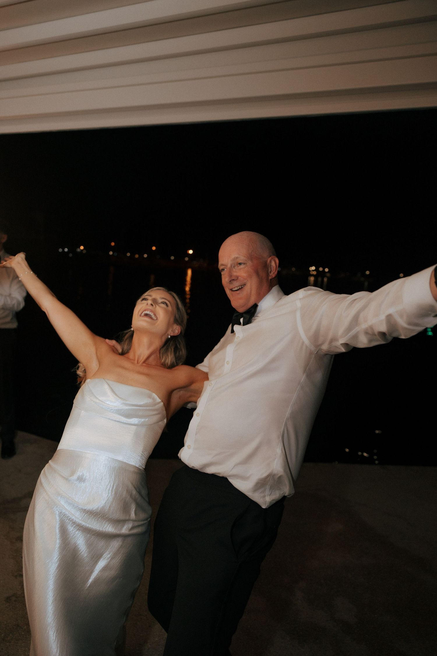 Joyful dancing sequence showing a couple performing playful twirls in formal attire.