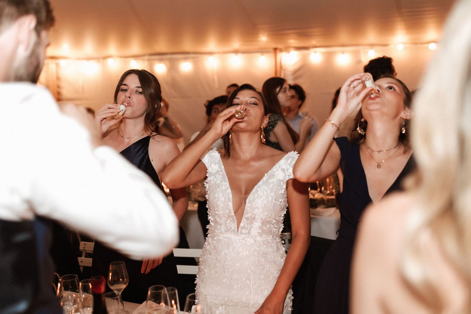 Celebratory moment at a wedding reception under warm lighting.
